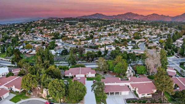 an aerial view of residential houses with outdoor space