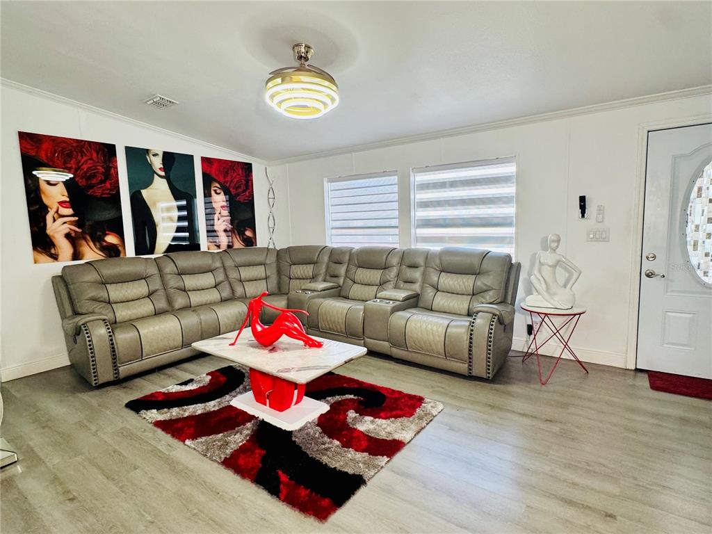18304 Cedarhurst Road Orlando, FL 32820 - Photo 12 of 24 a living room with furniture and wooden floor