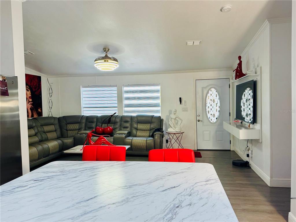 18304 Cedarhurst Road Orlando, FL 32820 - Photo 13 of 24 a bedroom with a bed cabinets and window