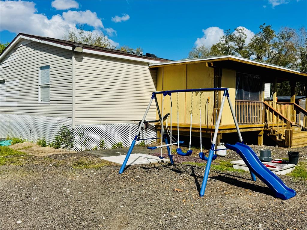 18304 Cedarhurst Road Orlando, FL 32820 - Photo 16 of 24 a view of a house with a slide