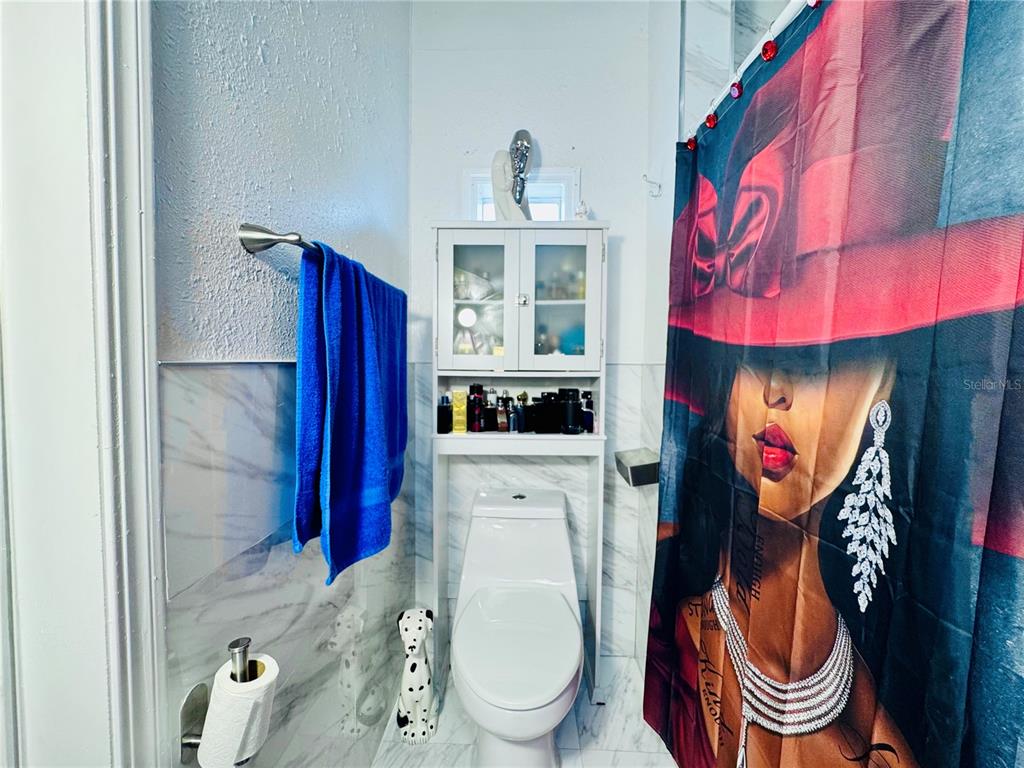 18304 Cedarhurst Road Orlando, FL 32820 - Photo 8 of 24 a bathroom with a sink a toilet and a mirror