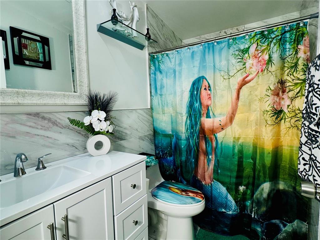 18304 Cedarhurst Road Orlando, FL 32820 - Photo 9 of 24 a bathroom with a sink a mirror and toilet