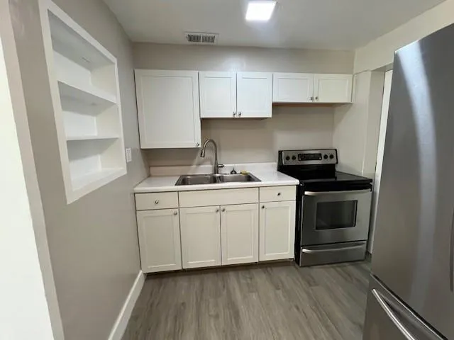 a kitchen with a stove and a refrigerator