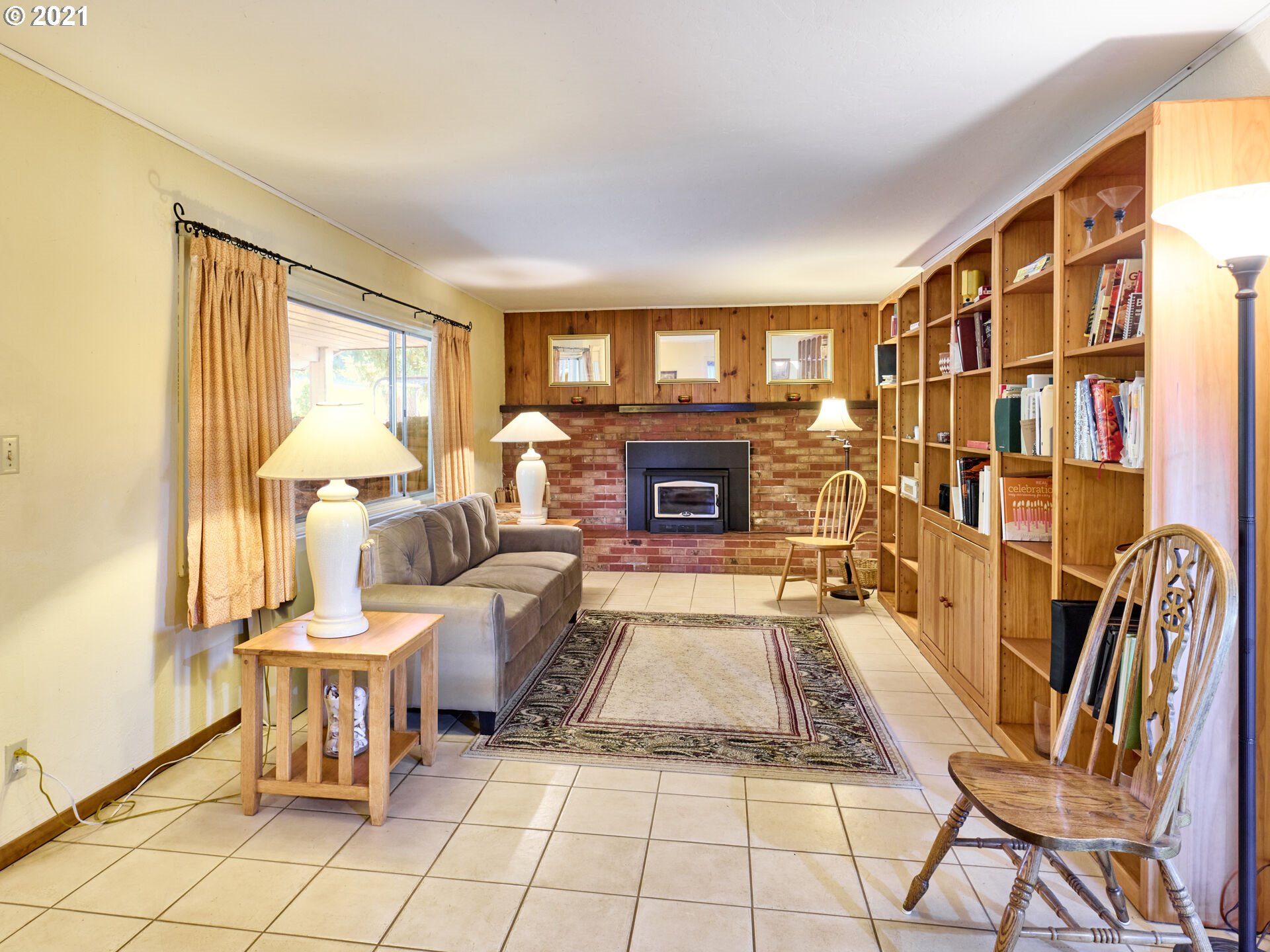 36799 South Hibbard Road Molalla, OR 97038 - Photo 8 of 32 a living room with furniture a fireplace and a large window