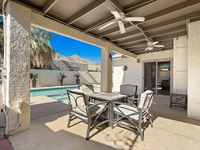 a view of a patio with table and chairs and potted plants