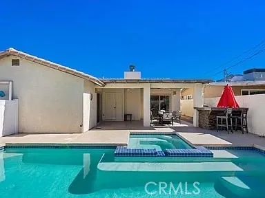a view of a house with swimming pool and sitting area