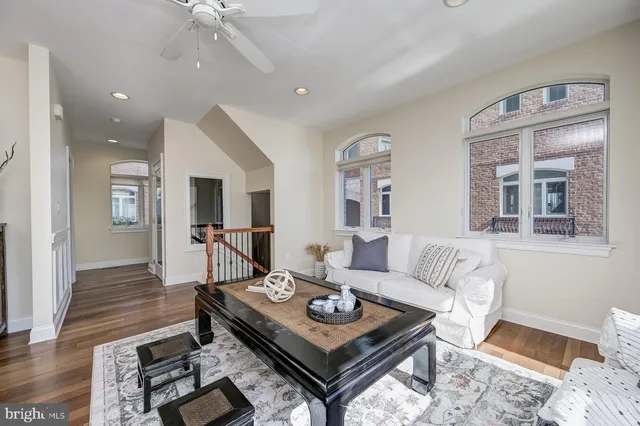 a kitchen with stainless steel appliances granite countertop a stove a sink dishwasher a dining table and chairs with wooden floor