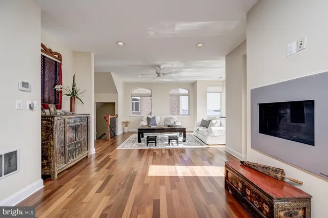 a view of a dining room with furniture a chandelier and wooden floor