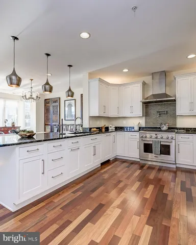 a spacious bathroom with a granite countertop sink mirror and a bathtub