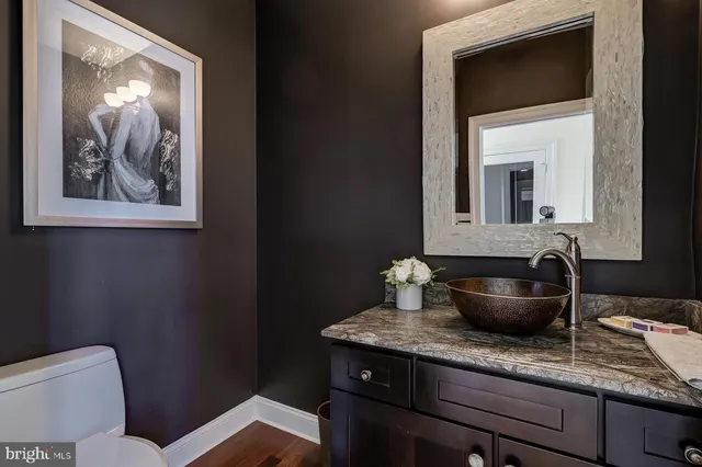 a spacious bathroom with a granite countertop tub sink and mirror