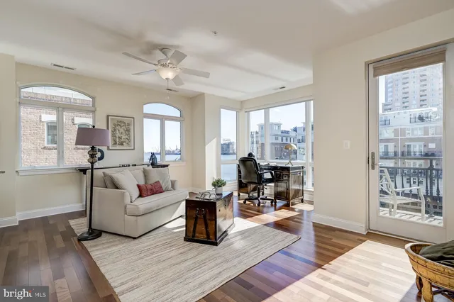 a living room with furniture and a floor to ceiling window