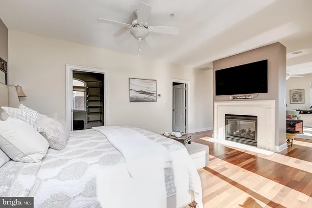 a spacious bedroom with a bed and a large window