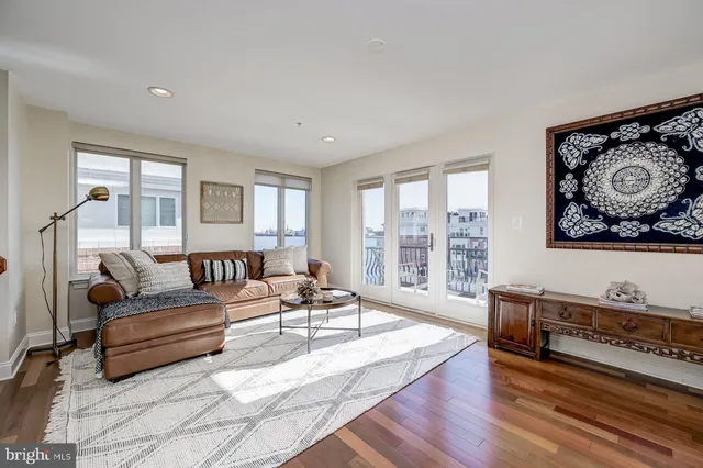 a front view of a building with a garden and plants