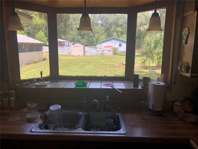 a bathroom with a shower sink and mirror