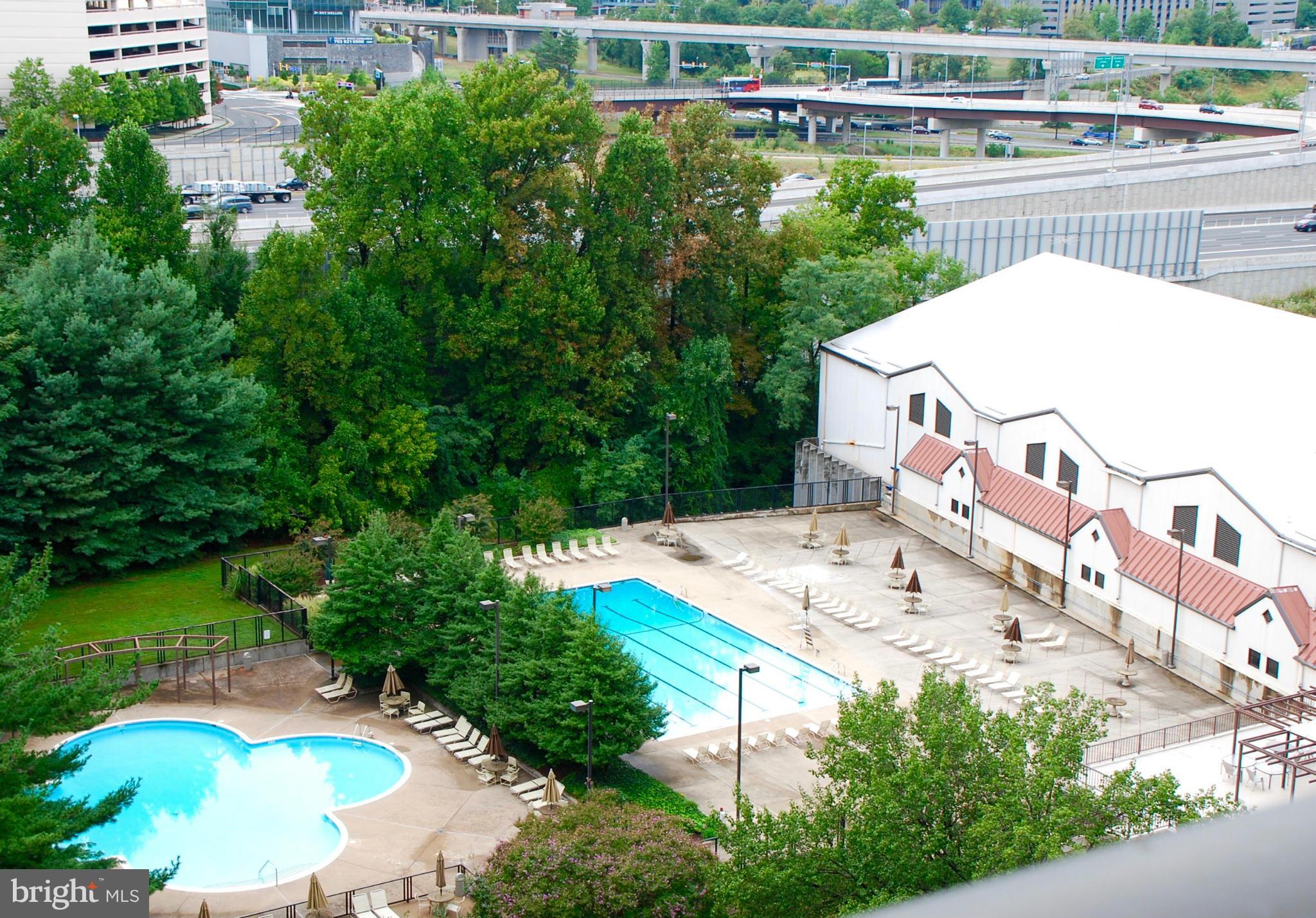 1800 Old Meadow Road, Unit 1510 McLean, VA 22102 - Photo 18 of 25 a view of a swimming pool with a patio and a garden