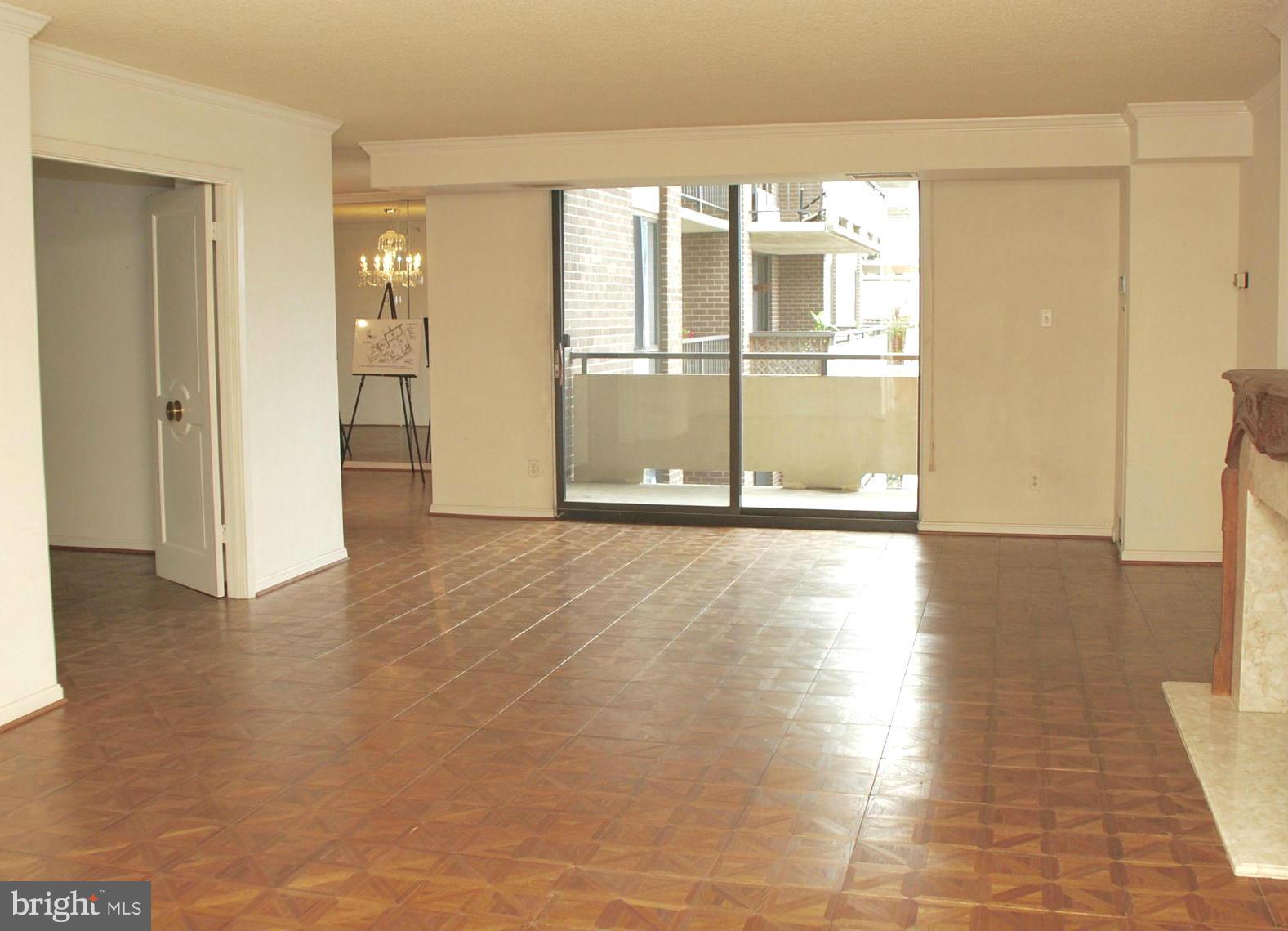 1800 Old Meadow Road, Unit 1510 McLean, VA 22102 - Photo 4 of 25 a view of an empty room with wooden floor and a window