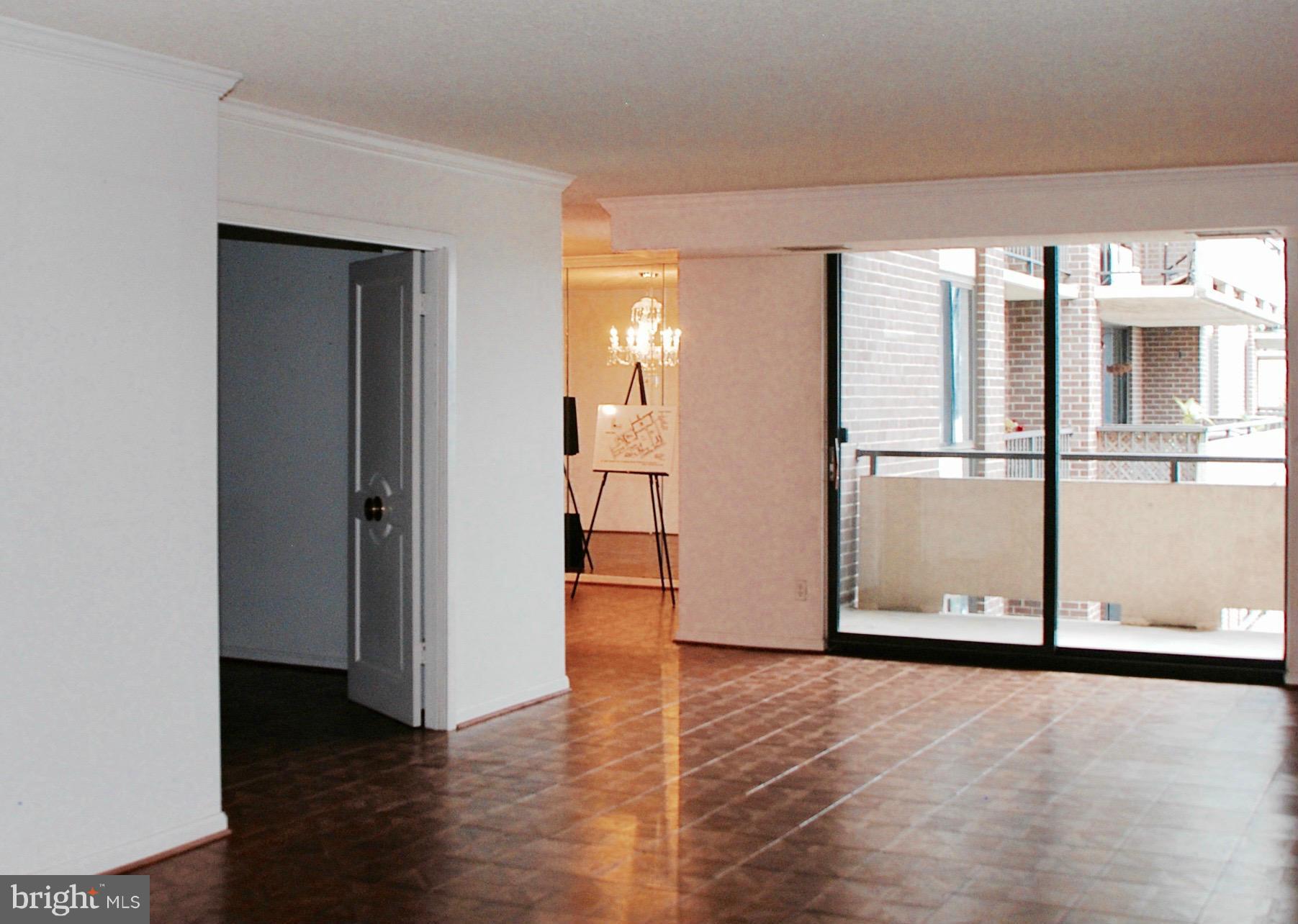 1800 Old Meadow Road, Unit 1510 McLean, VA 22102 - Photo 6 of 25 a view of a room with wooden floor and a kitchen
