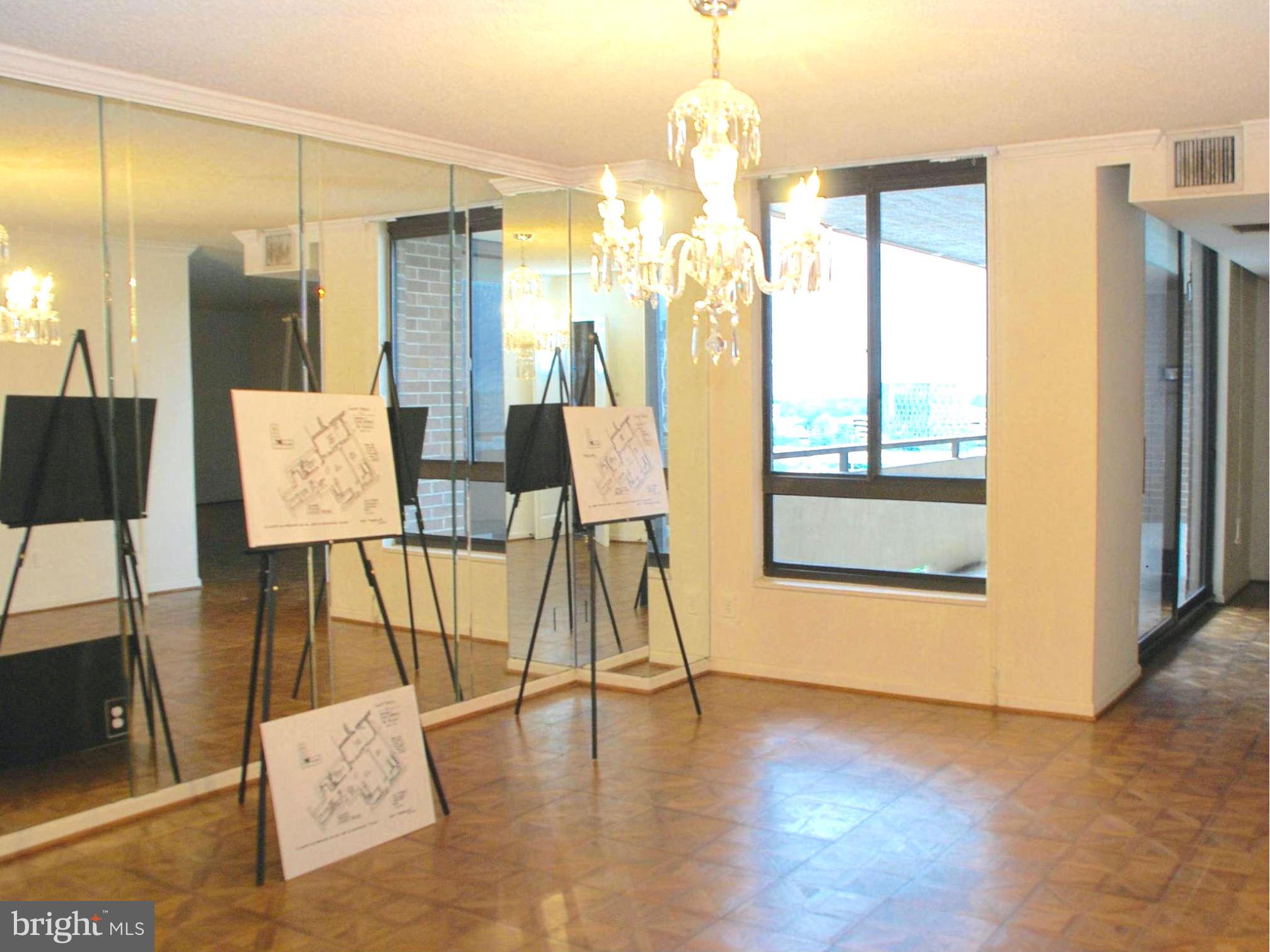 1800 Old Meadow Road, Unit 1510 McLean, VA 22102 - Photo 7 of 25 a view of a dining room with furniture and wooden floor