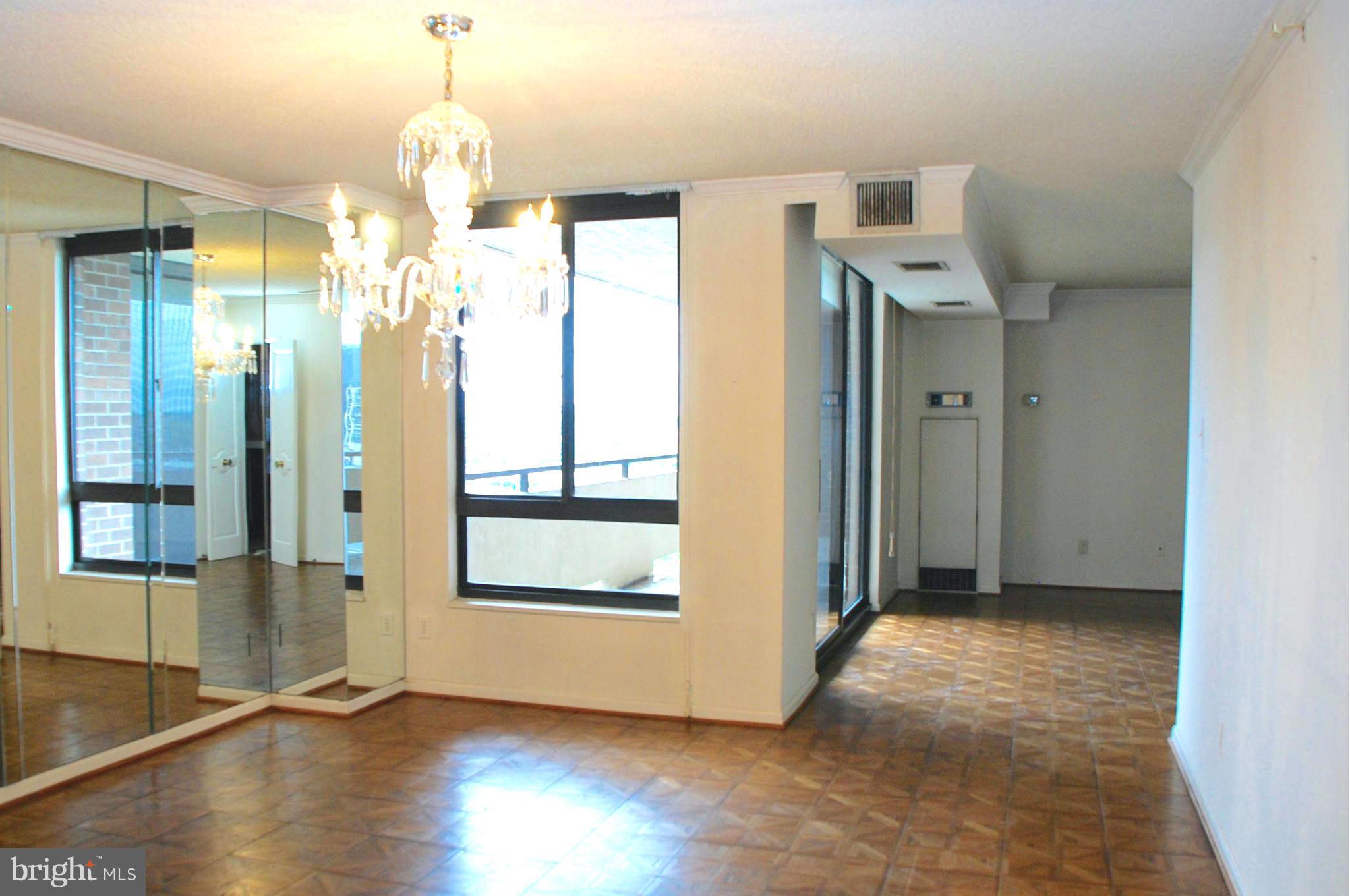 1800 Old Meadow Road, Unit 1510 McLean, VA 22102 - Photo 8 of 25 a view of a hallway with wooden floor and chandelier