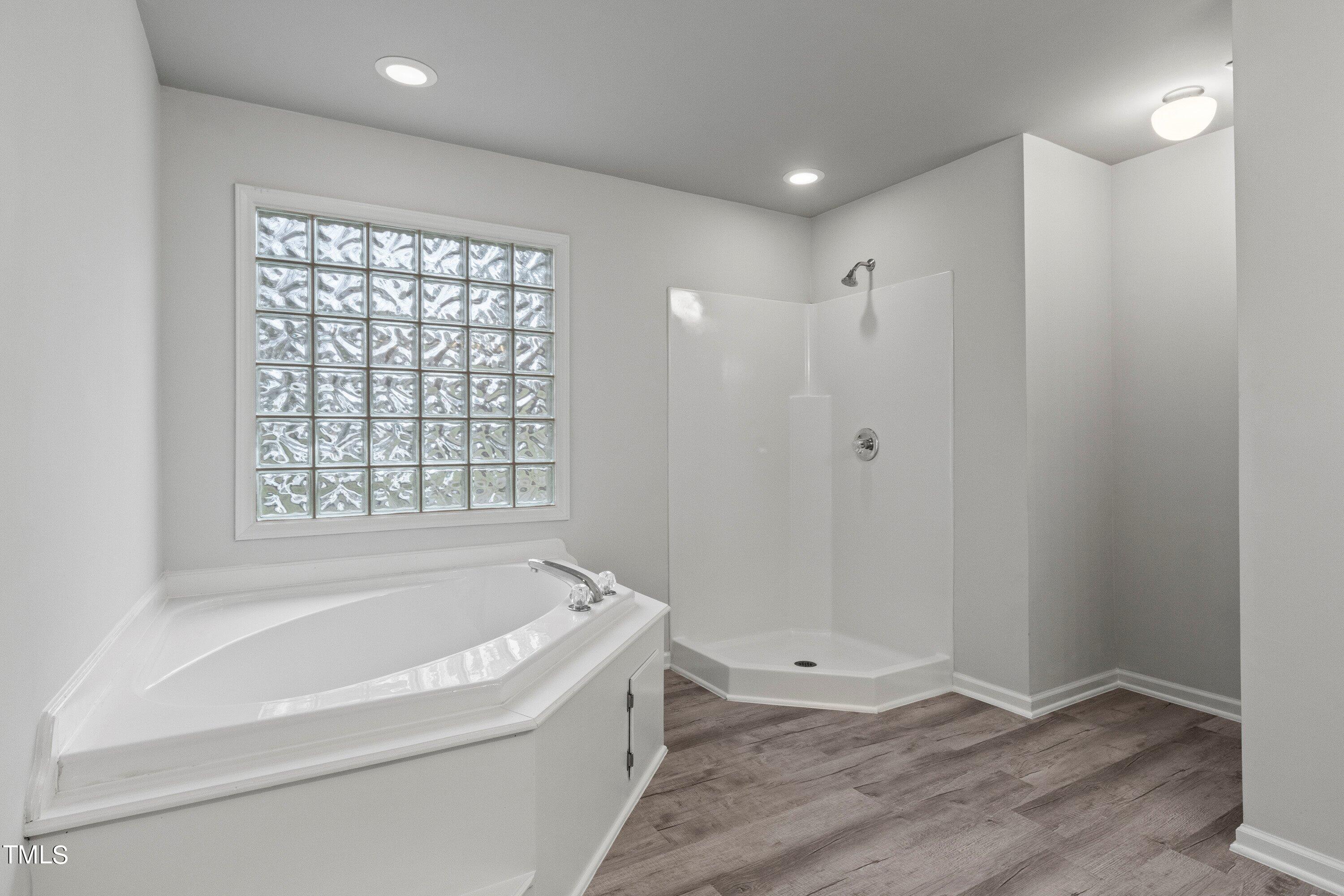 505 Castleberry Road Clayton, NC 27527 - Photo 12 of 38 a bathroom with a bathtub and shower