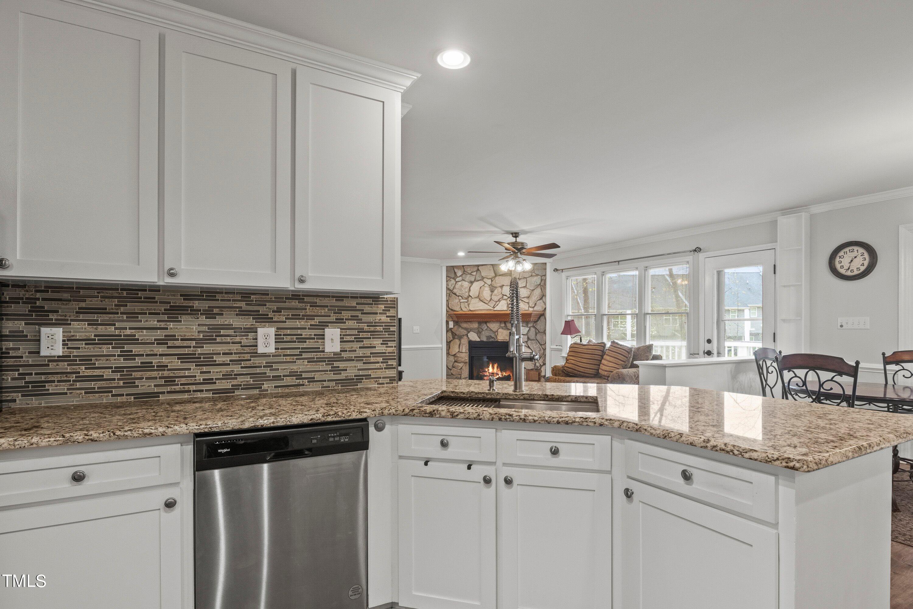 505 Castleberry Road Clayton, NC 27527 - Photo 18 of 38 a kitchen with granite countertop a sink and cabinets