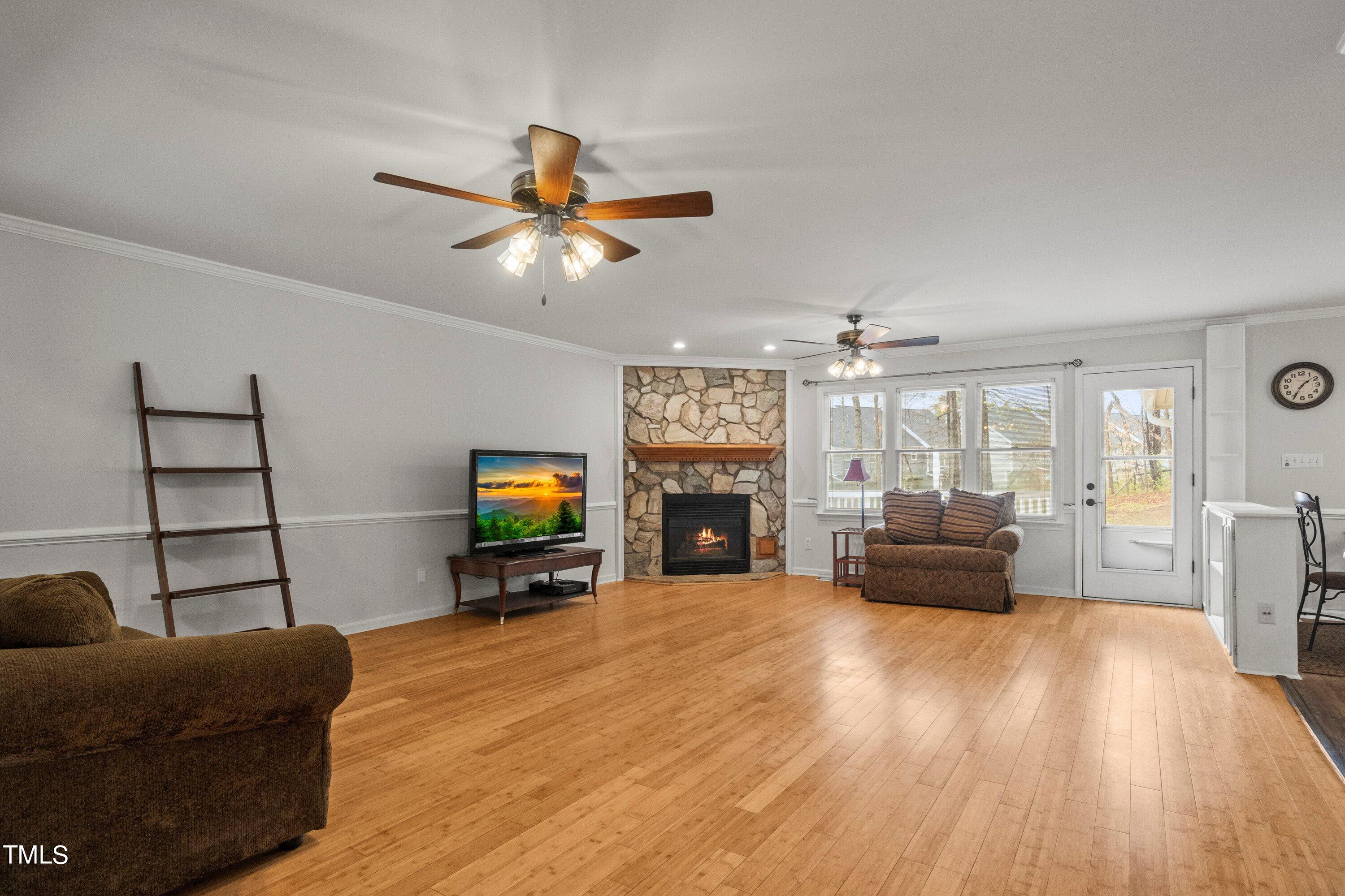 505 Castleberry Road Clayton, NC 27527 - Photo 19 of 38 a living room with furniture and a flat screen tv