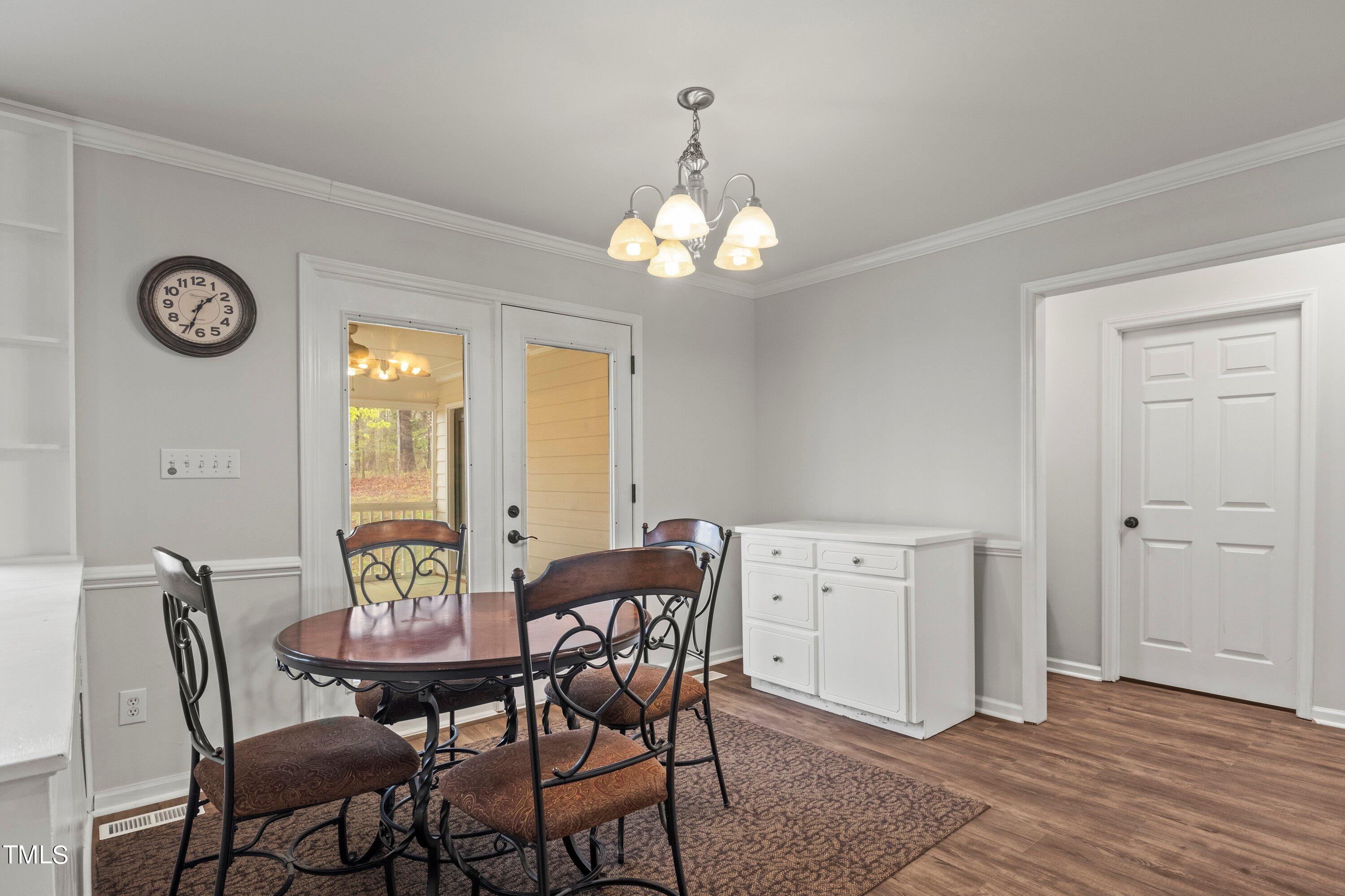 505 Castleberry Road Clayton, NC 27527 - Photo 21 of 38 a view of a dining room with furniture and a chandelier