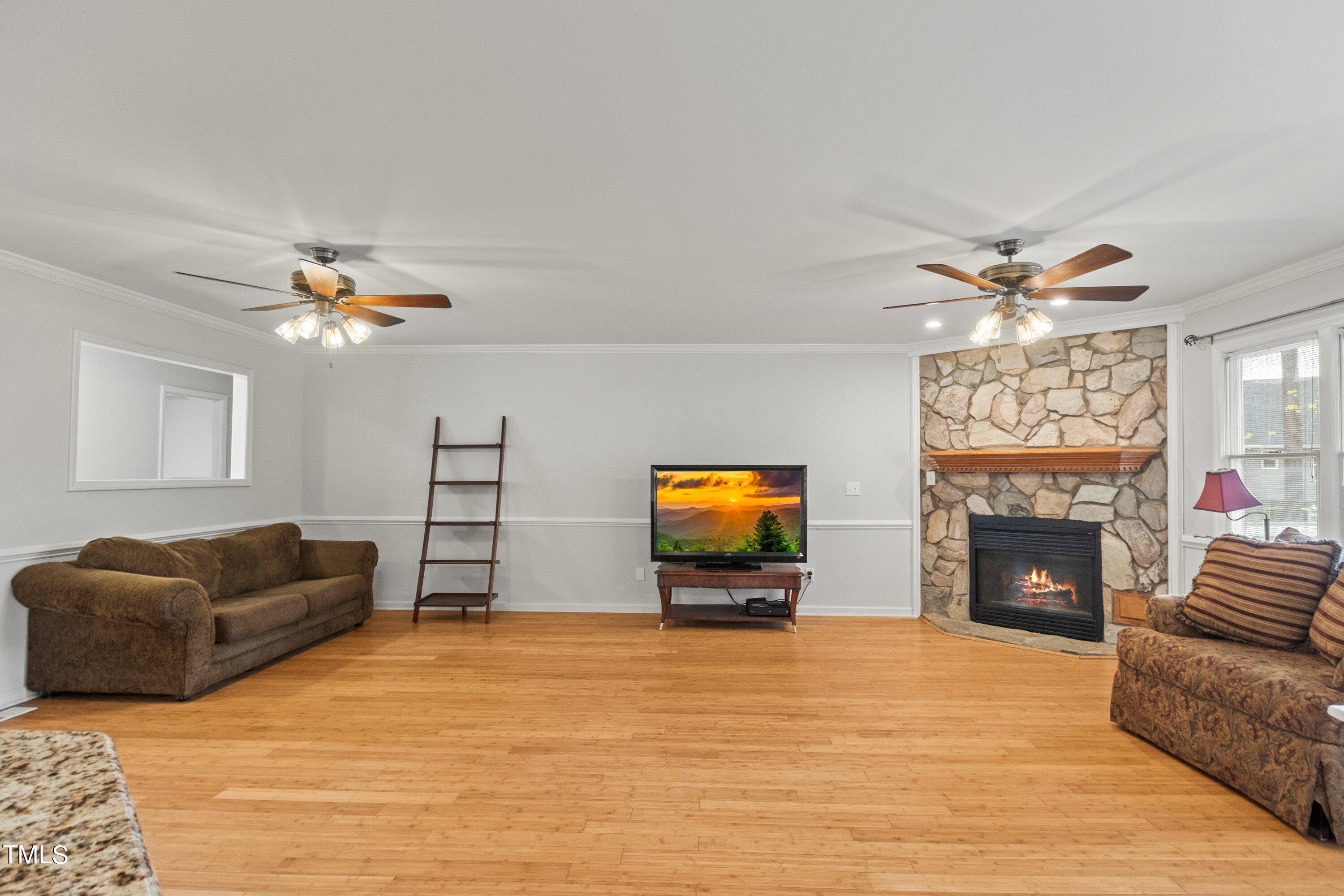 505 Castleberry Road Clayton, NC 27527 - Photo 24 of 38 a living room with furniture and a fireplace