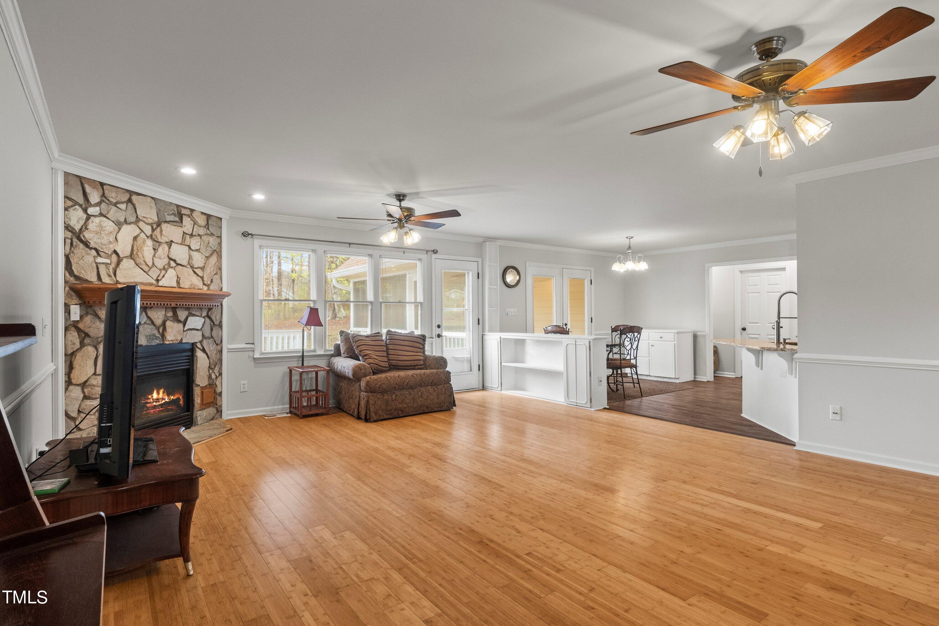 505 Castleberry Road Clayton, NC 27527 - Photo 25 of 38 a large bedroom with a bed and a chandelier