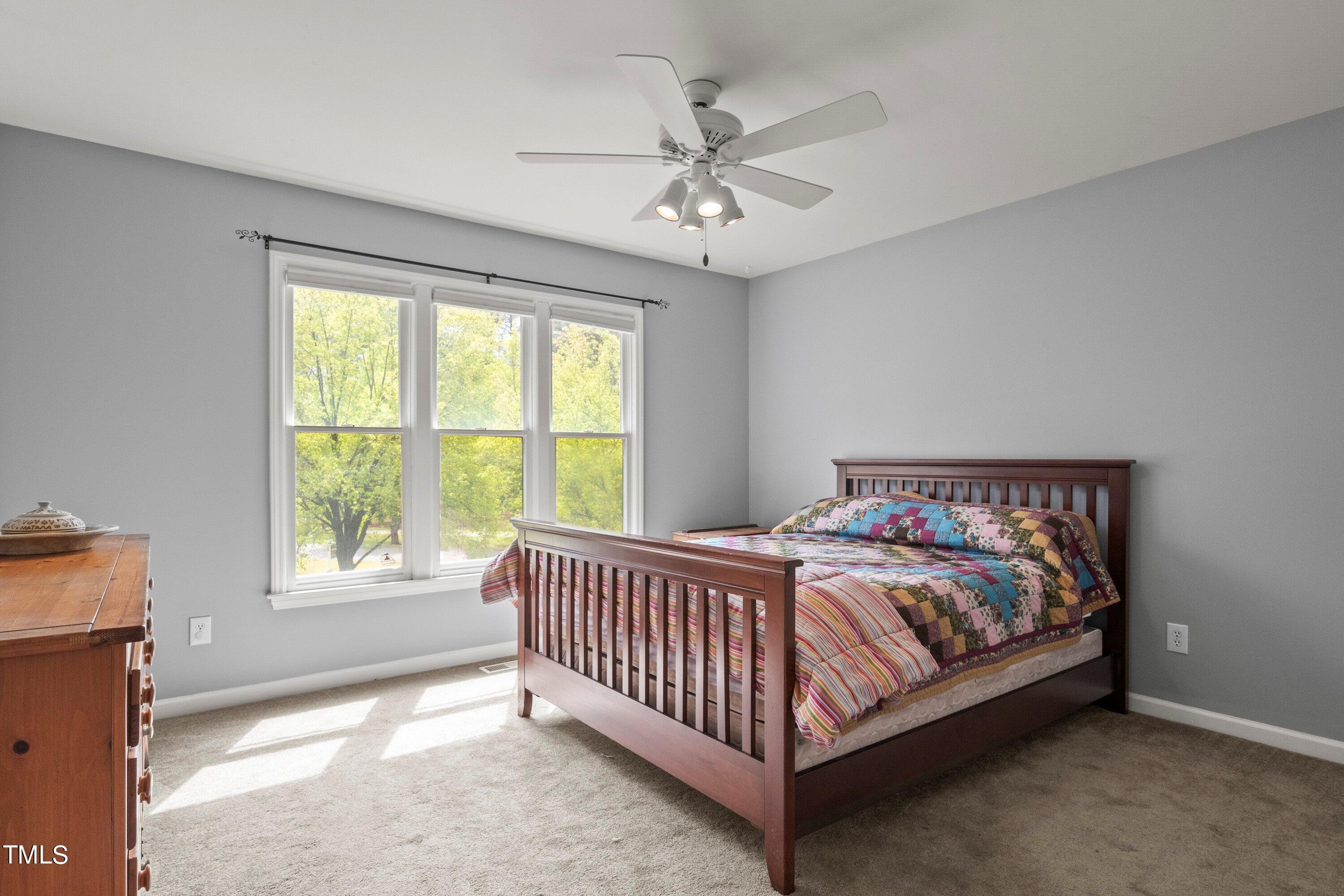 505 Castleberry Road Clayton, NC 27527 - Photo 26 of 38 a bed sitting in a bedroom next to a window