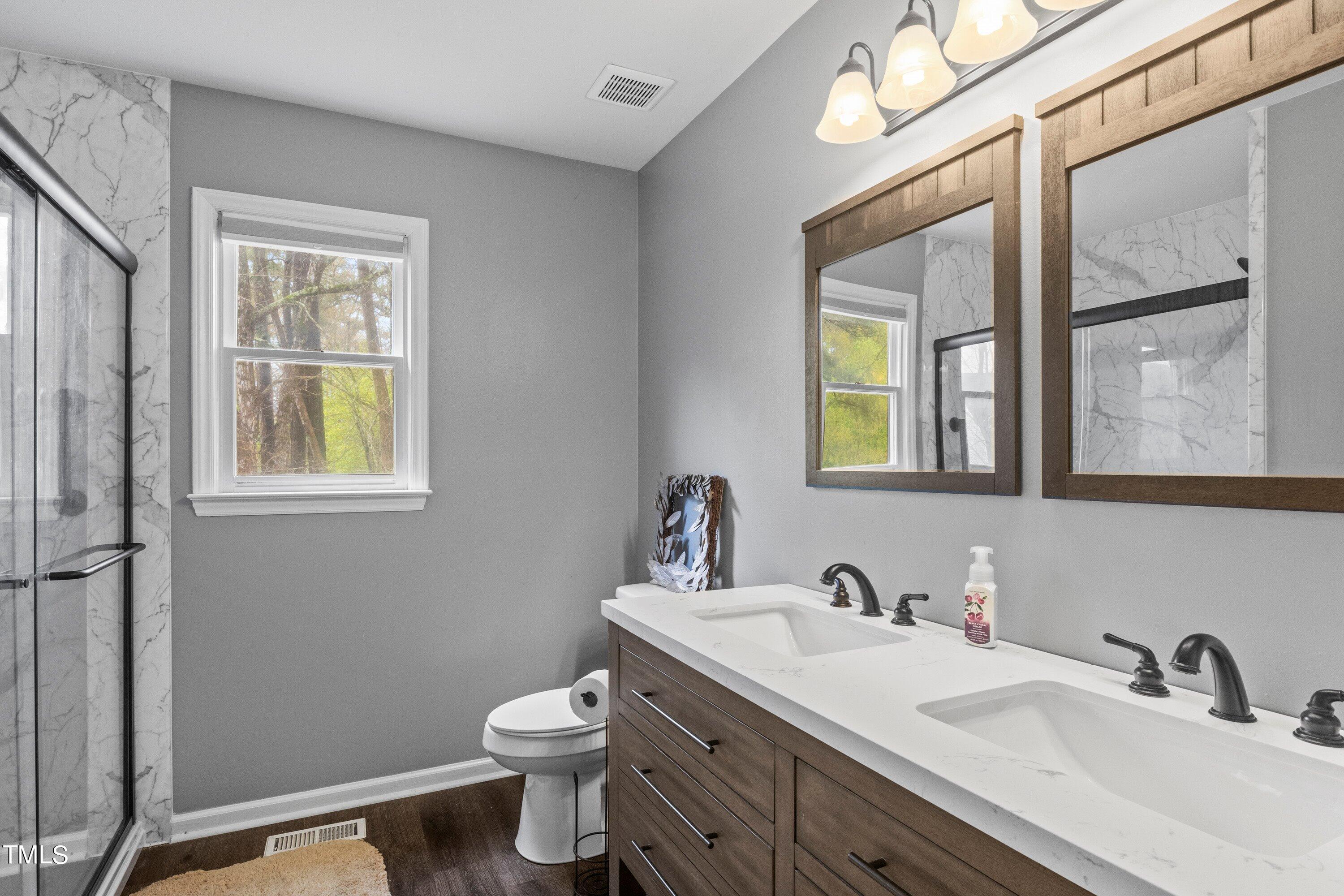 505 Castleberry Road Clayton, NC 27527 - Photo 27 of 38 a bathroom with 2 sink and a toilet