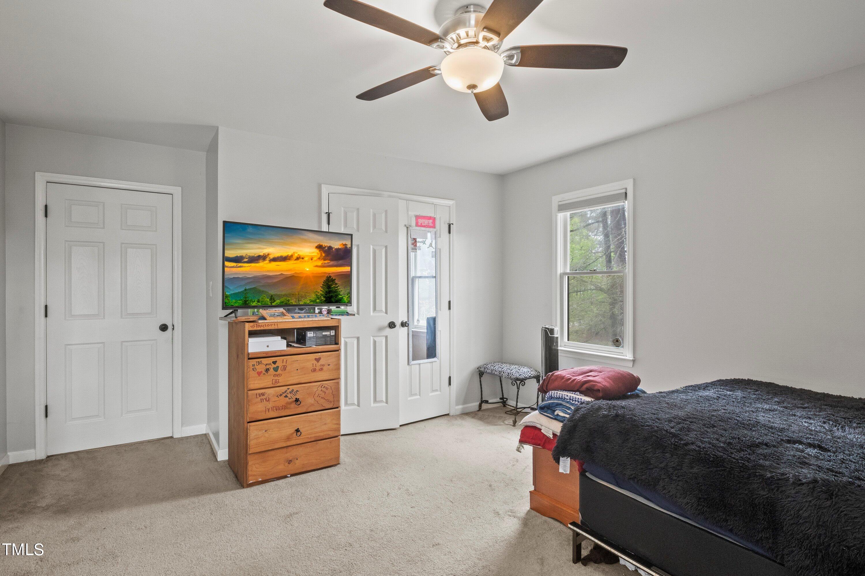 505 Castleberry Road Clayton, NC 27527 - Photo 29 of 38 a bedroom with a bed and a flat screen tv