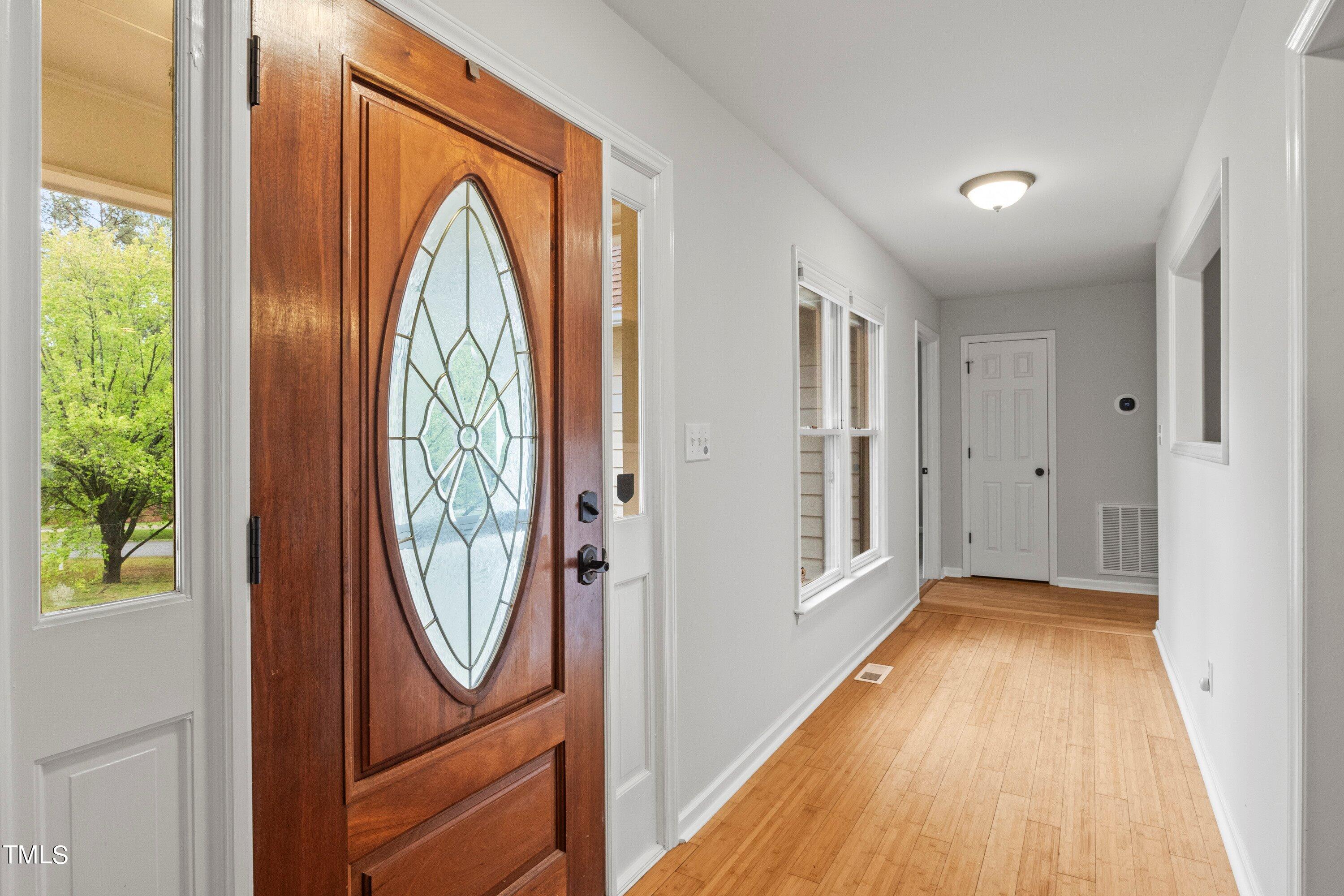 505 Castleberry Road Clayton, NC 27527 - Photo 30 of 38 a view of a hallway with wooden floor and windows