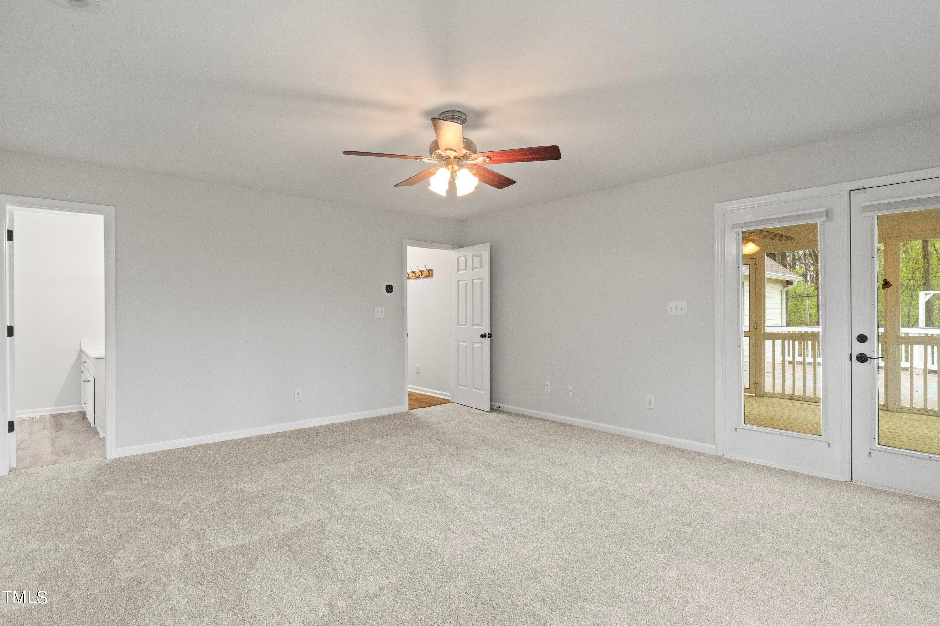 505 Castleberry Road Clayton, NC 27527 - Photo 9 of 38 a view of an empty room with a ceiling fan and window