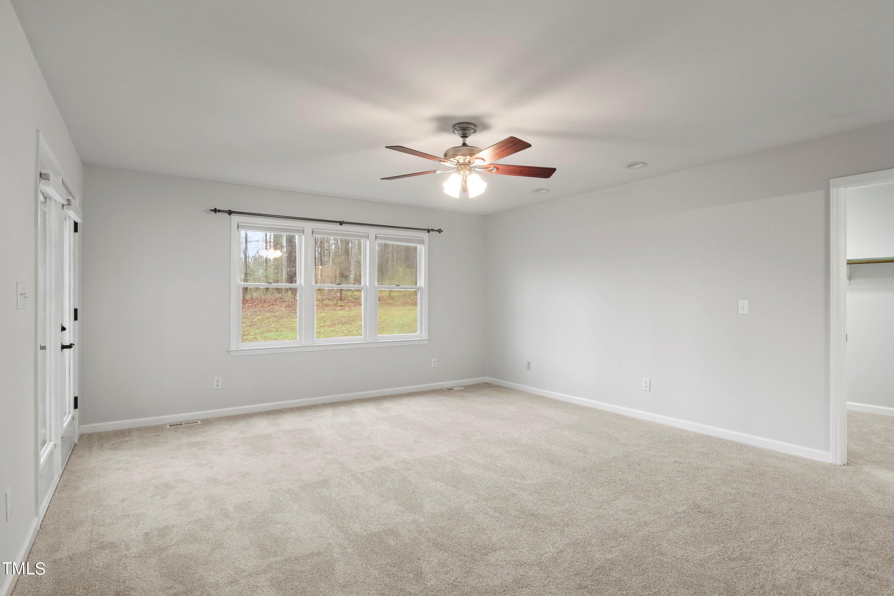 505 Castleberry Road Clayton, NC 27527 - Photo 10 of 38 a view of an empty room with a window