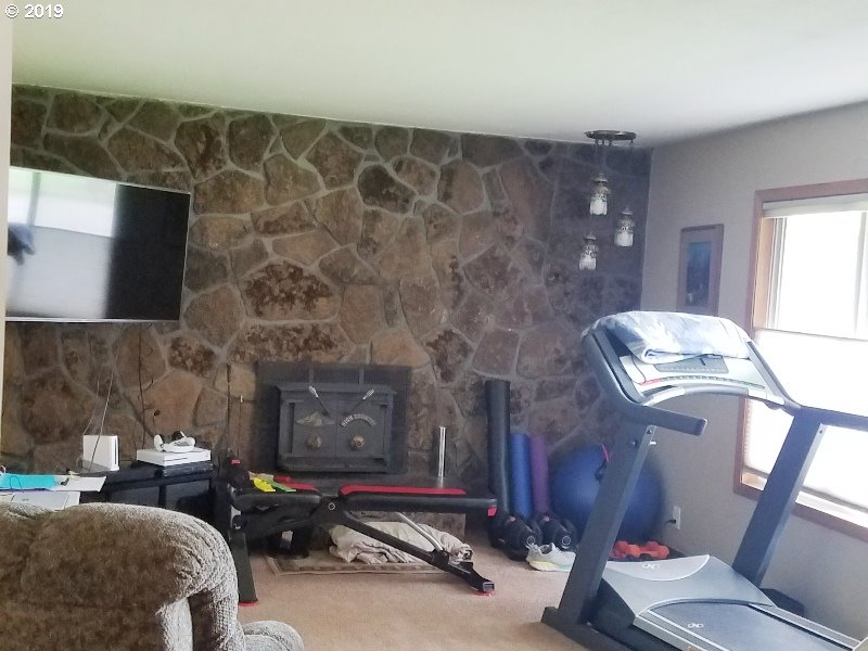 23805 South Rondevic Road Canby, OR 97013 - Photo 11 of 15 a living room with furniture and a fireplace