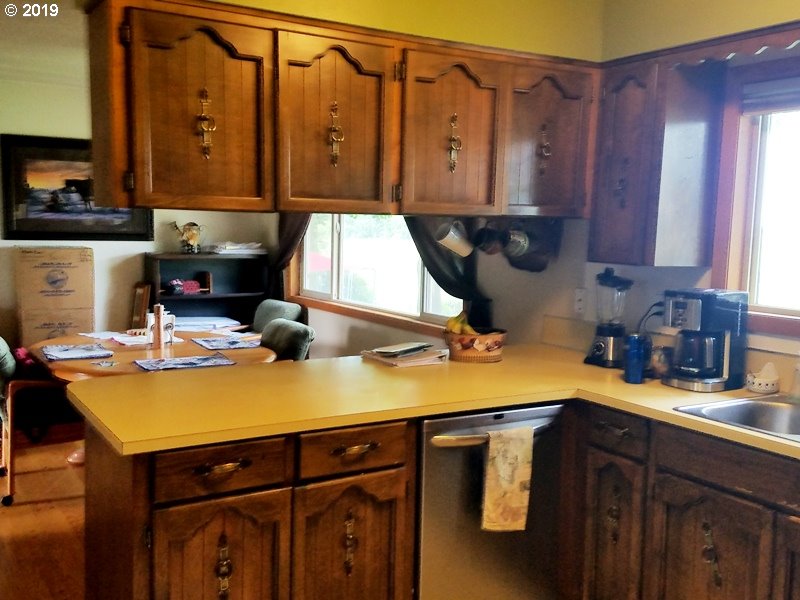 23805 South Rondevic Road Canby, OR 97013 - Photo 12 of 15 a kitchen with a sink and cabinets