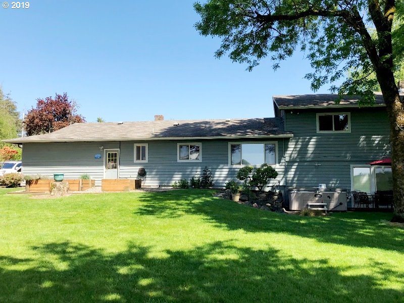 23805 South Rondevic Road Canby, OR 97013 - Photo 3 of 15 a front view of a house with a garden and plants