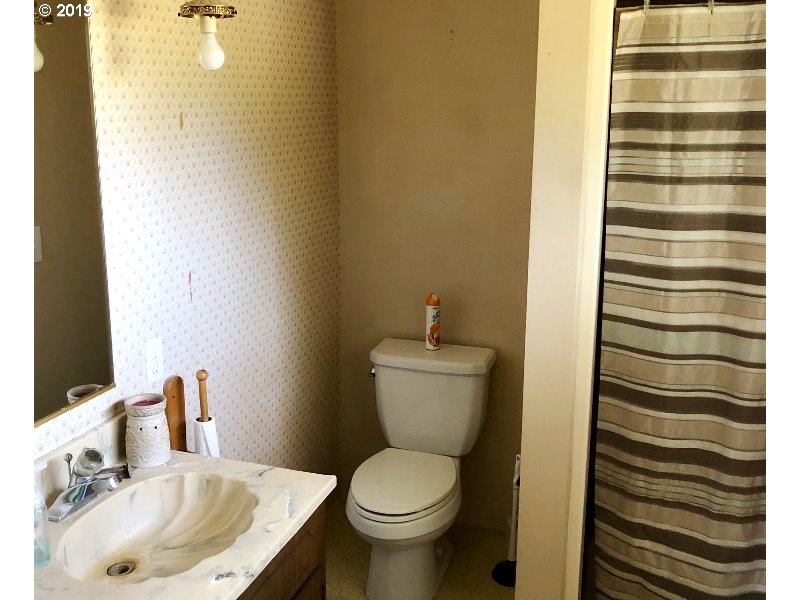 23805 South Rondevic Road Canby, OR 97013 - Photo 7 of 15 a bathroom with a sink toilet and shower