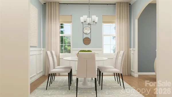 a view of a dining room with furniture and a chandelier