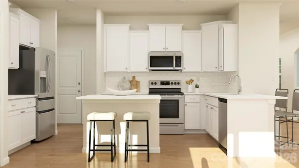 a kitchen with stainless steel appliances a table and chairs