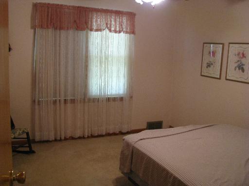 3380 Sadler Road Morris, IL 60450 - Photo 8 of 14 a bed sitting in a bedroom next to a window