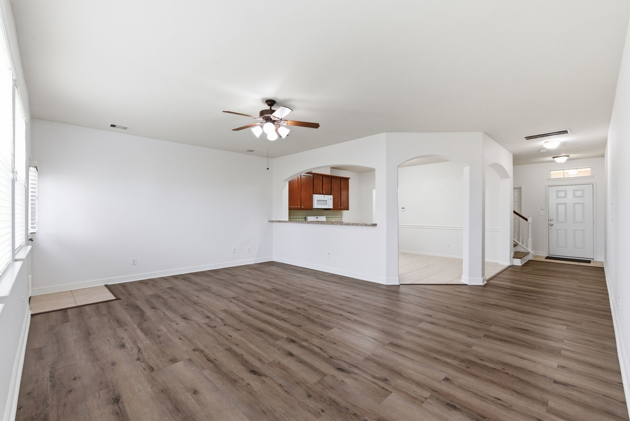 10510 Day Trail Lane Spring, TX 77379 - Photo 4 of 23 Moving past the entry, you are greeted by an expansive, open-concept living room highlighted by gorgeous, carpet-free laminate flooring.