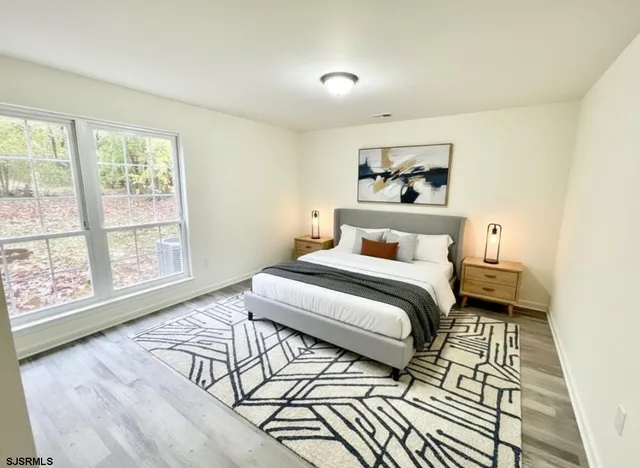 a bedroom with a bed and a large window