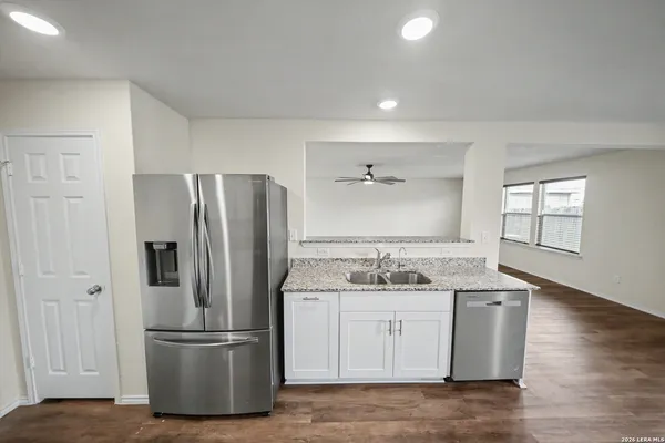 a kitchen with kitchen island a sink appliances and cabinets