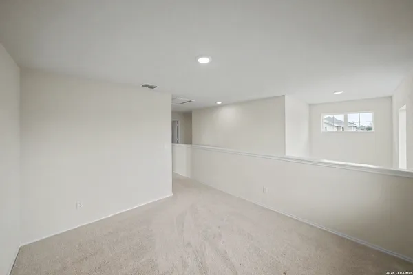 an empty room with a empty space and windows