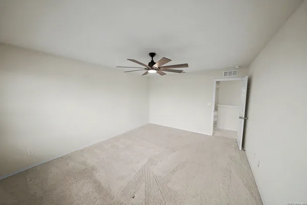 a view of a big room with closet and fan