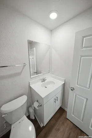 a bathroom with a toilet sink and mirror