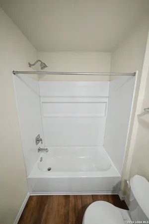 a bathroom with a bathtub and toilet