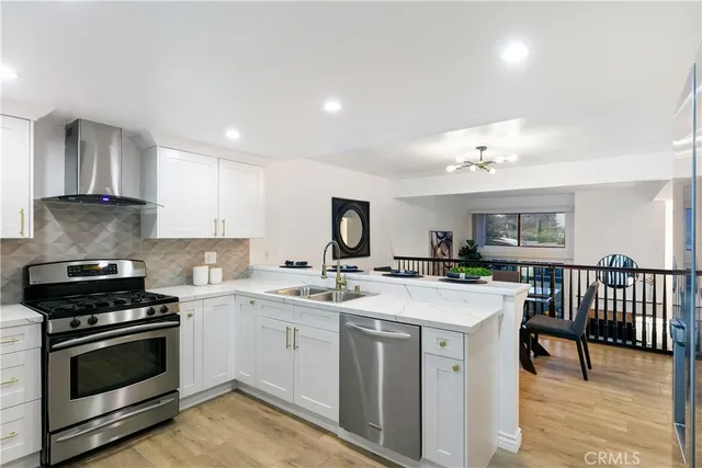 a kitchen with a stove a sink and a refrigerator